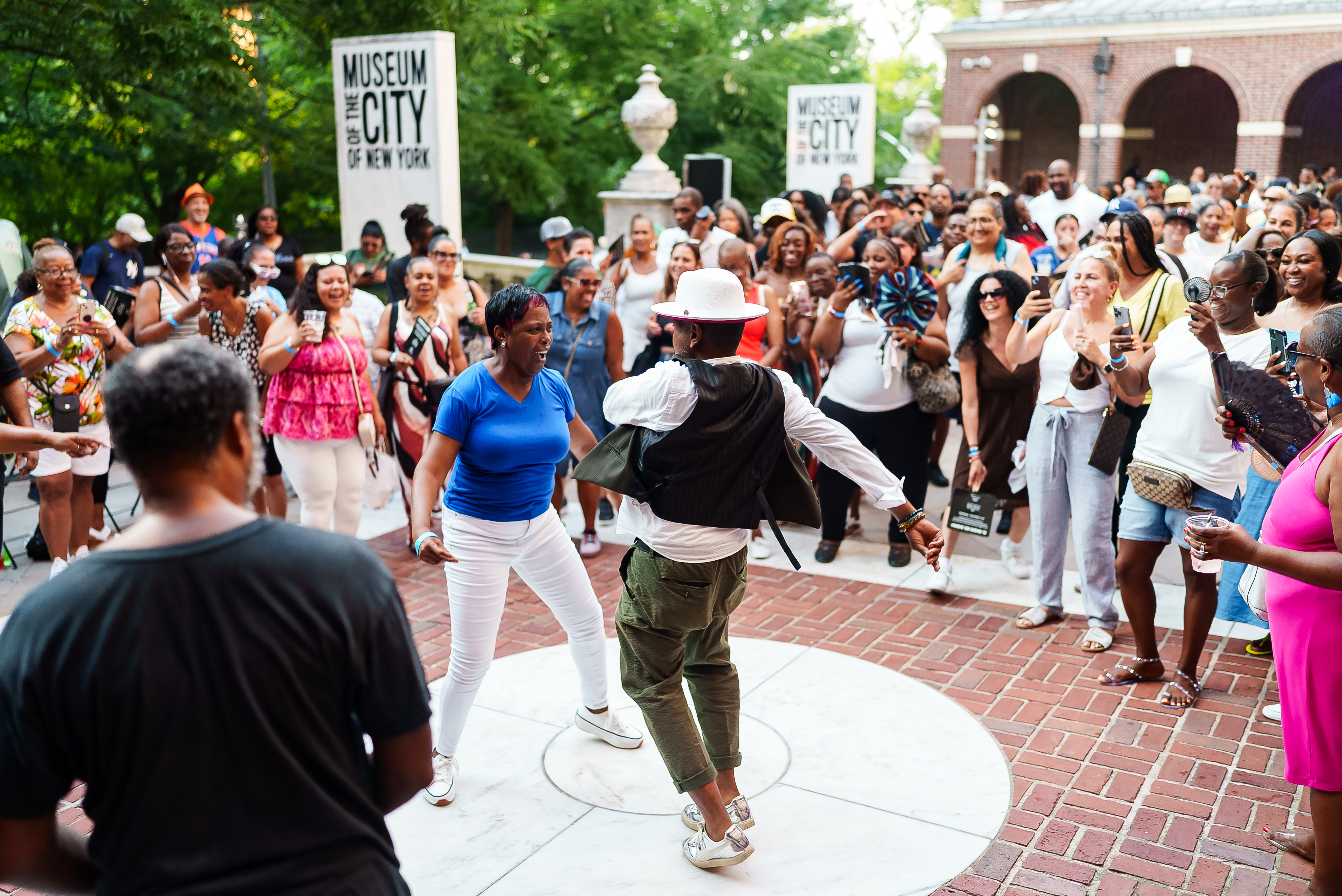 Two people dancing on the front terrace of the Museum of the City of New York